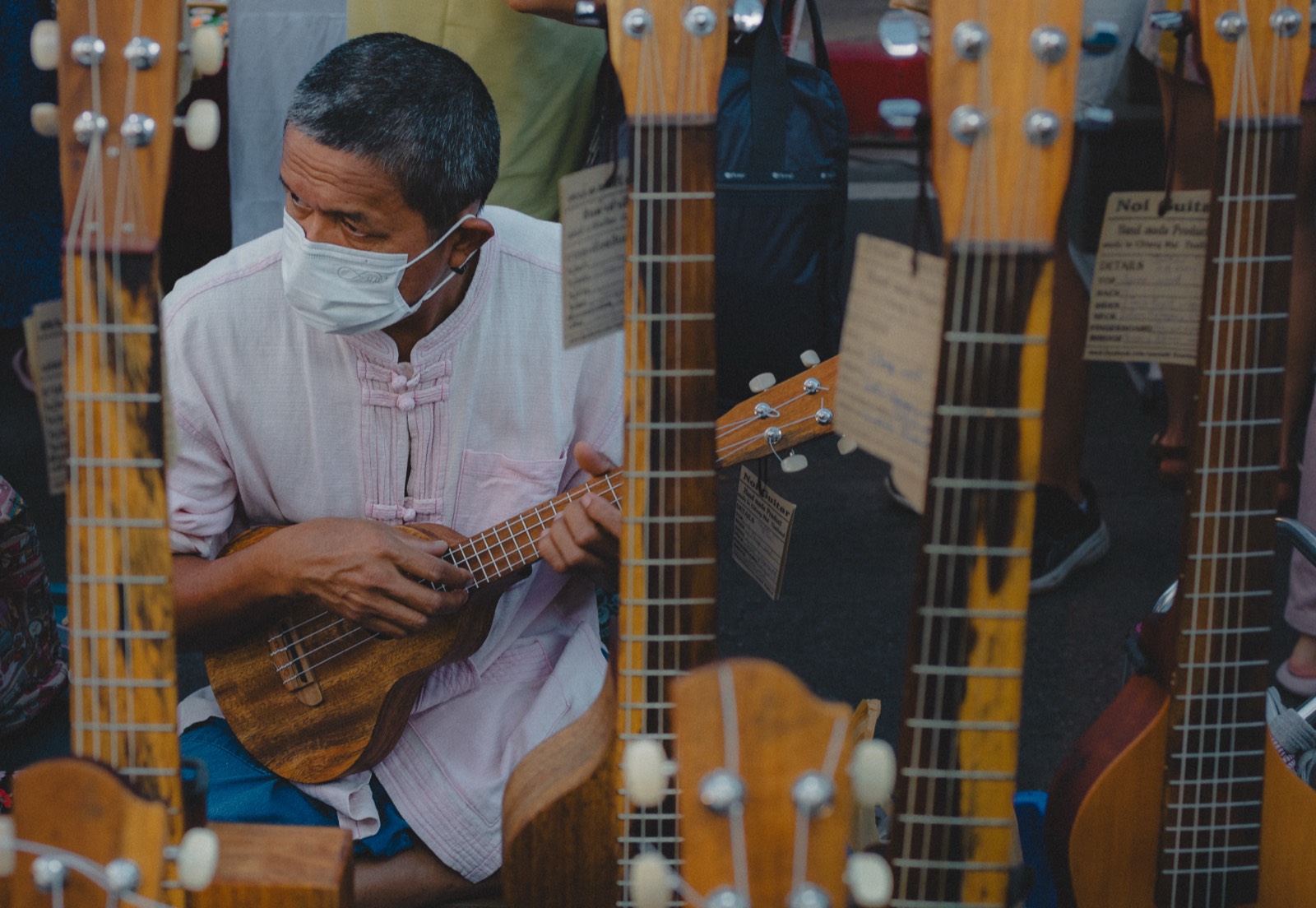 Street musician playing ukulele at a market in Chiang Mai, Thailand