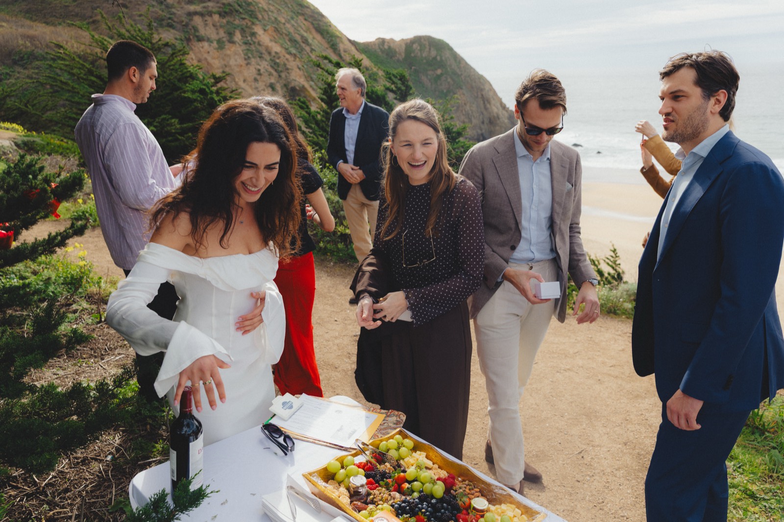 Outdoor celebration on a coastal hillside with ocean view